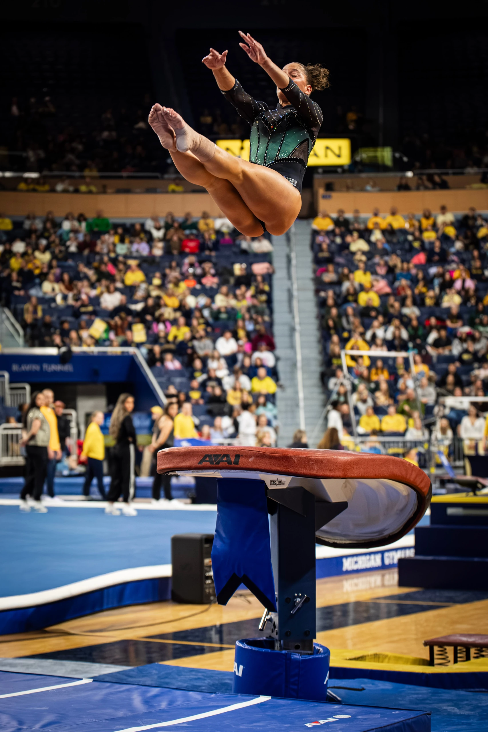 Sage Kellerman airborne above the vault table in competition